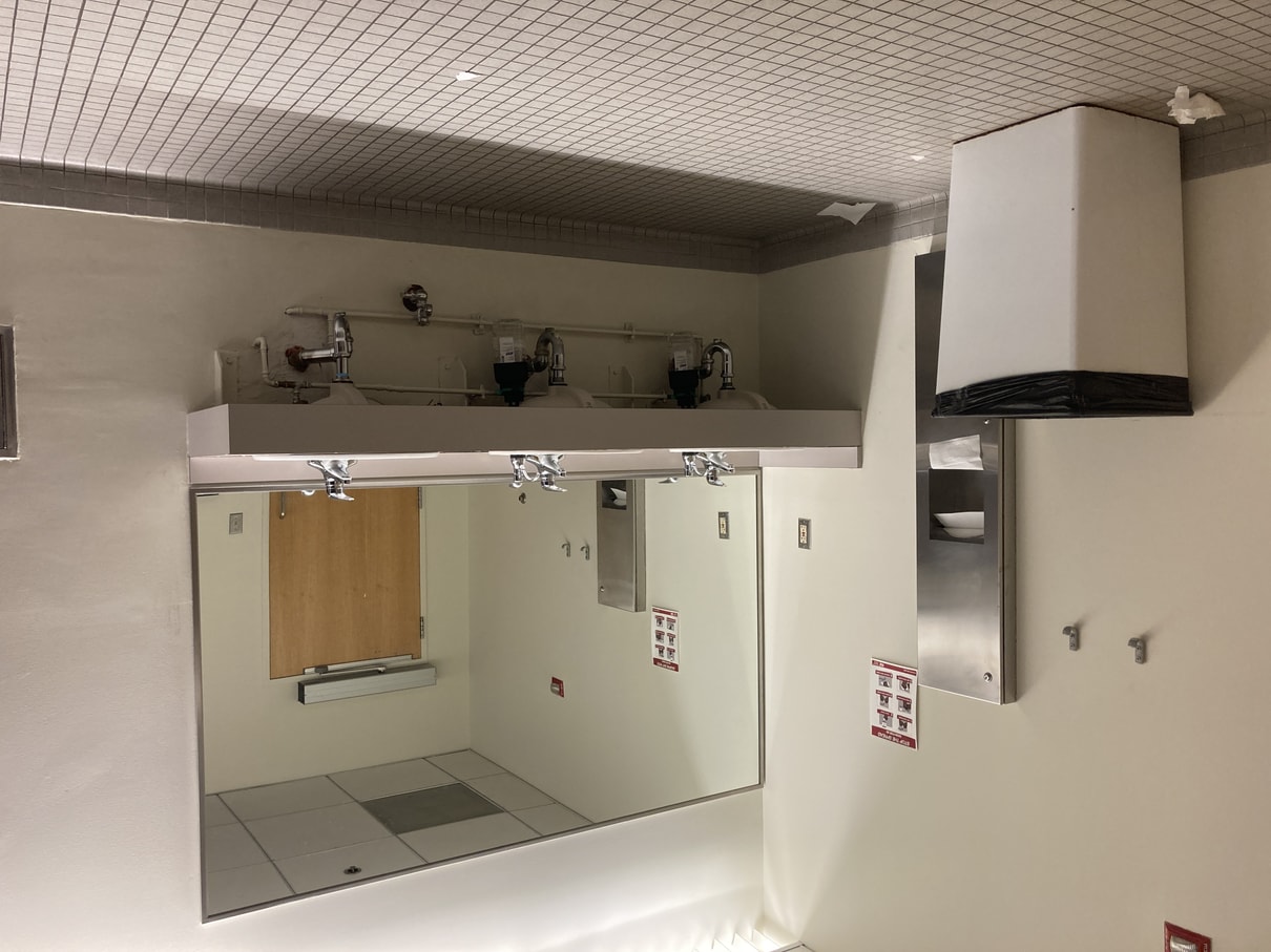 Photo of bathroom sink and trashcan with regular lighting